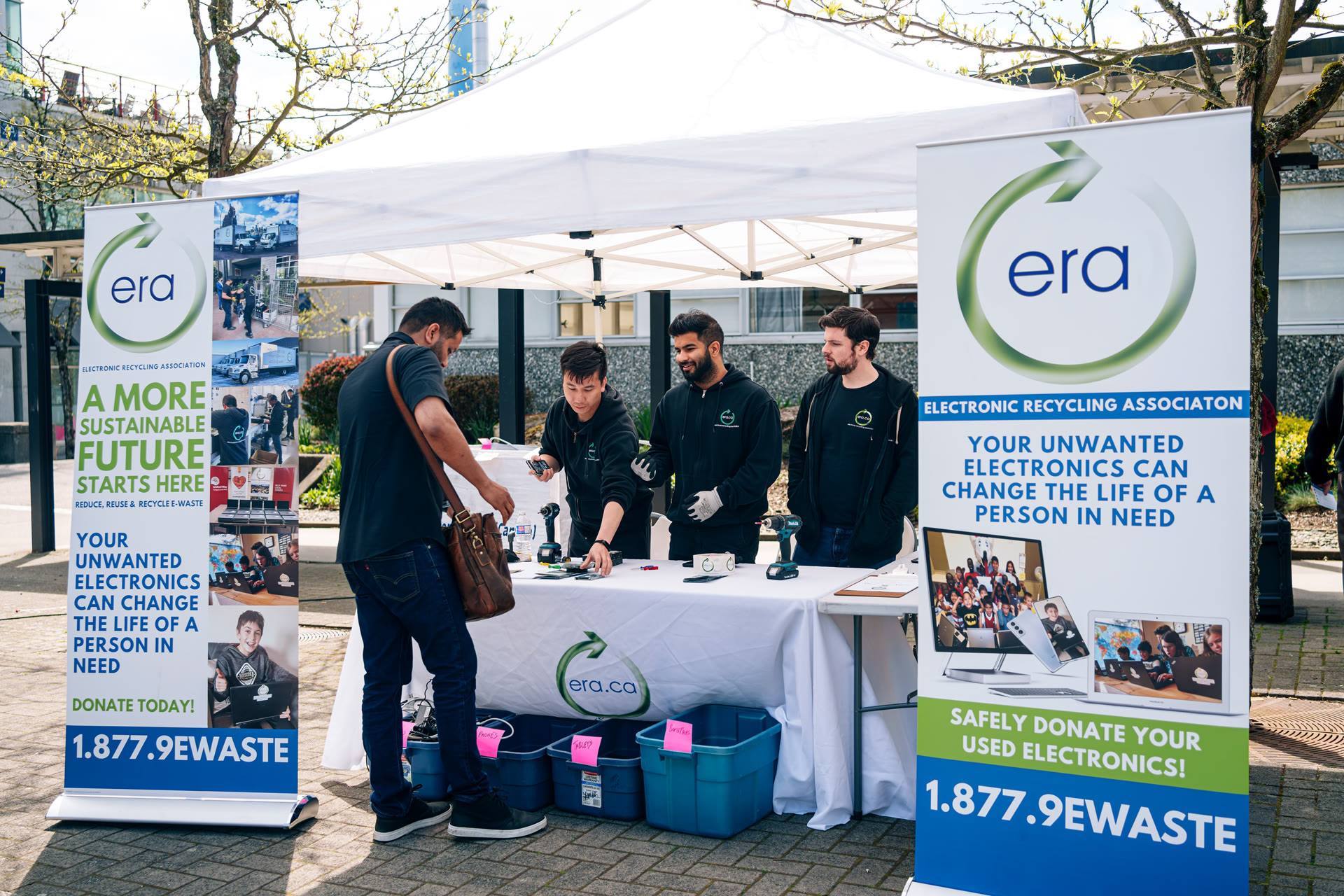 ERA team members receiving retired electronics at a community collection event