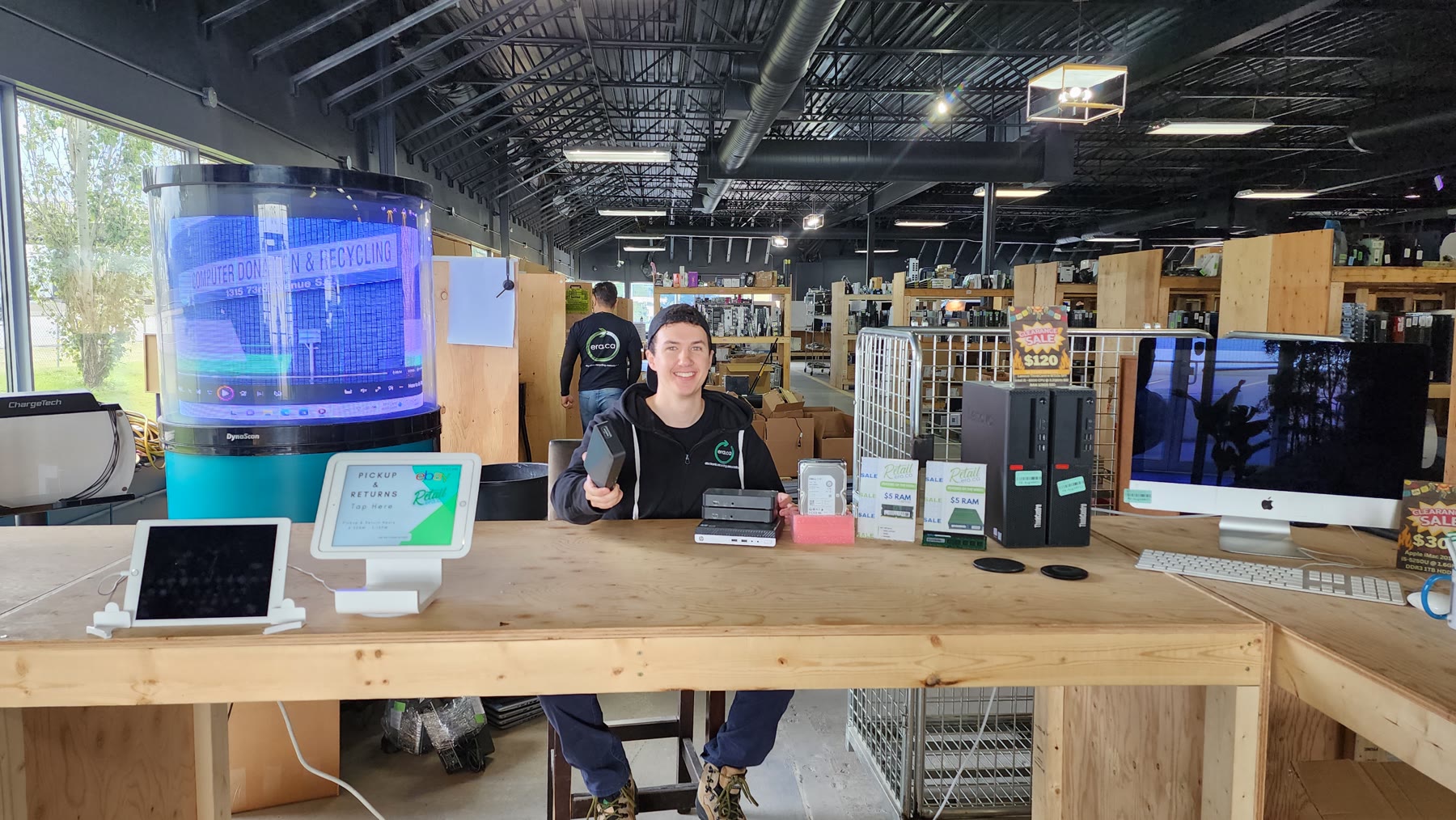 An ERA team member presenting refurbished computers ready for a second life
