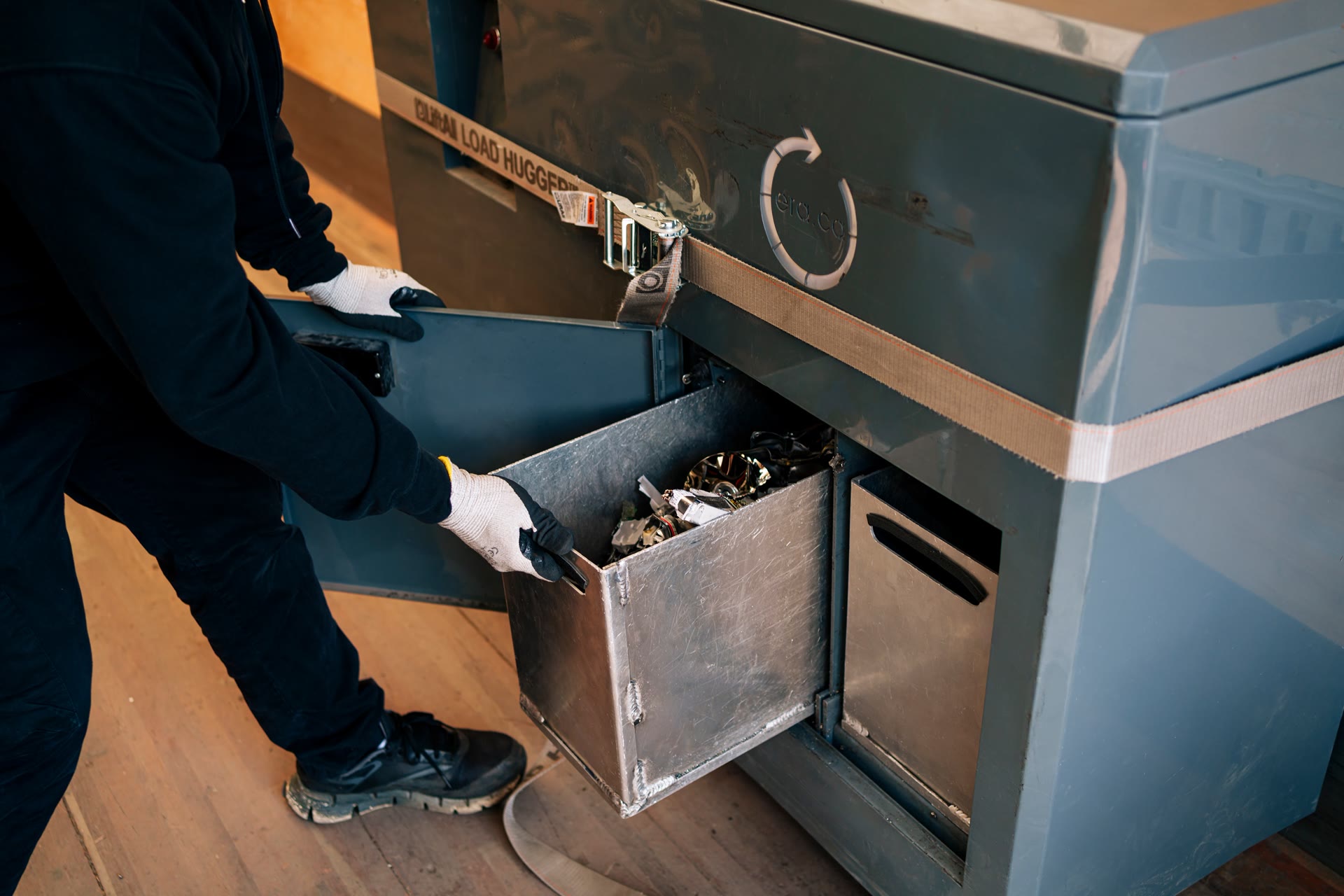 An ERA technician loading recovered electronic components into secure processing equipment