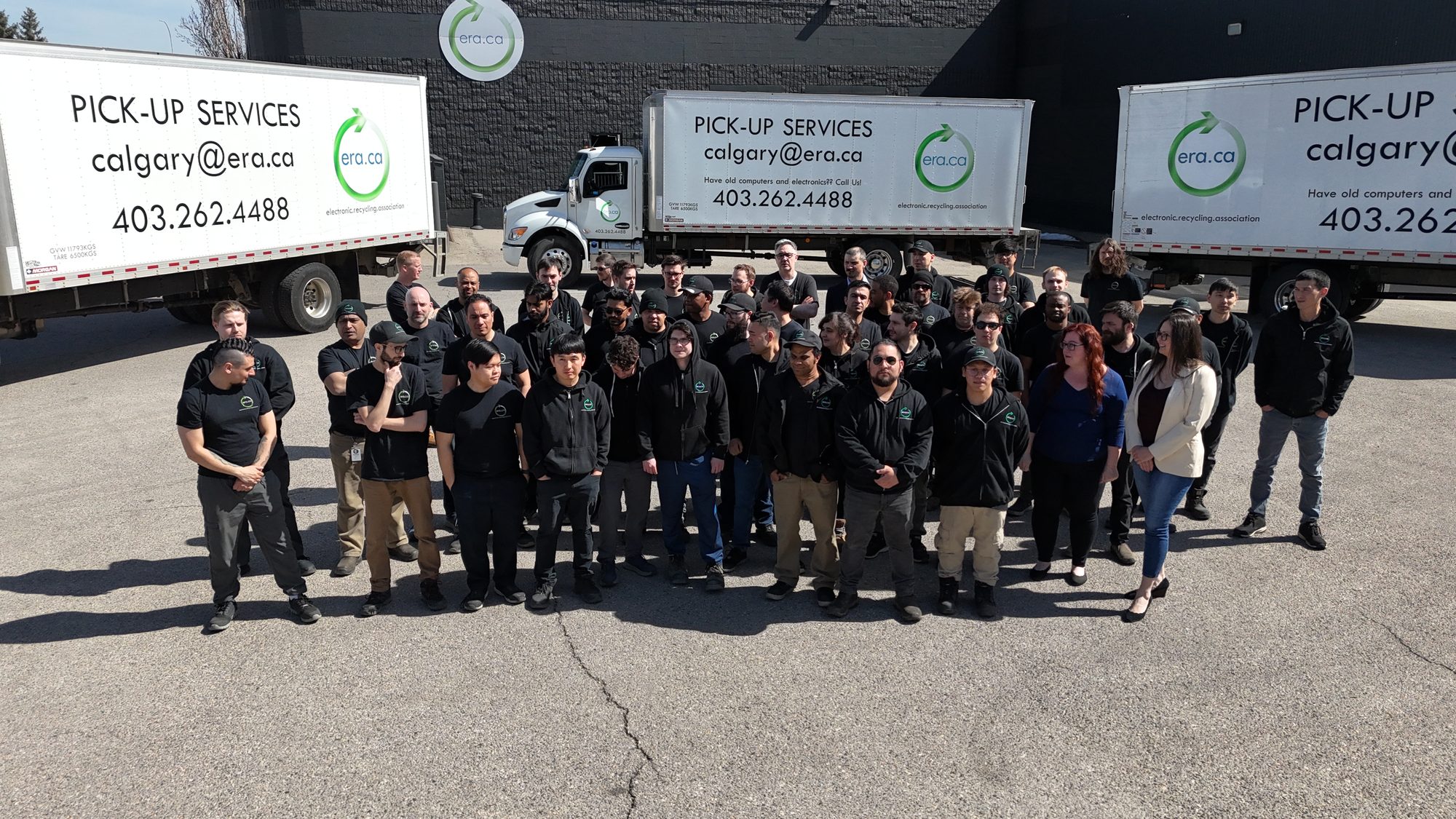 The ERA team gathered beside collection trucks