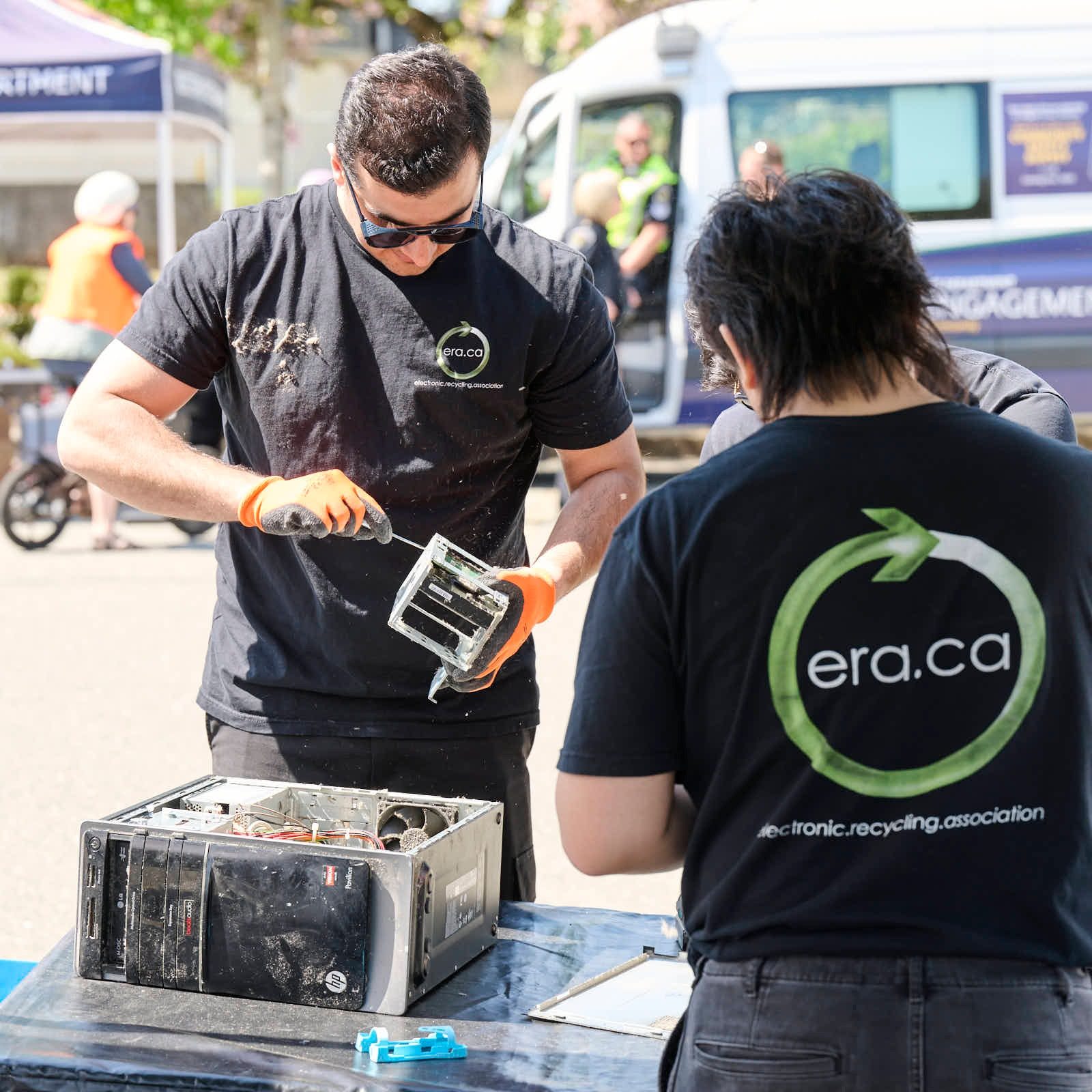 ERA team members working on a computer at a community event