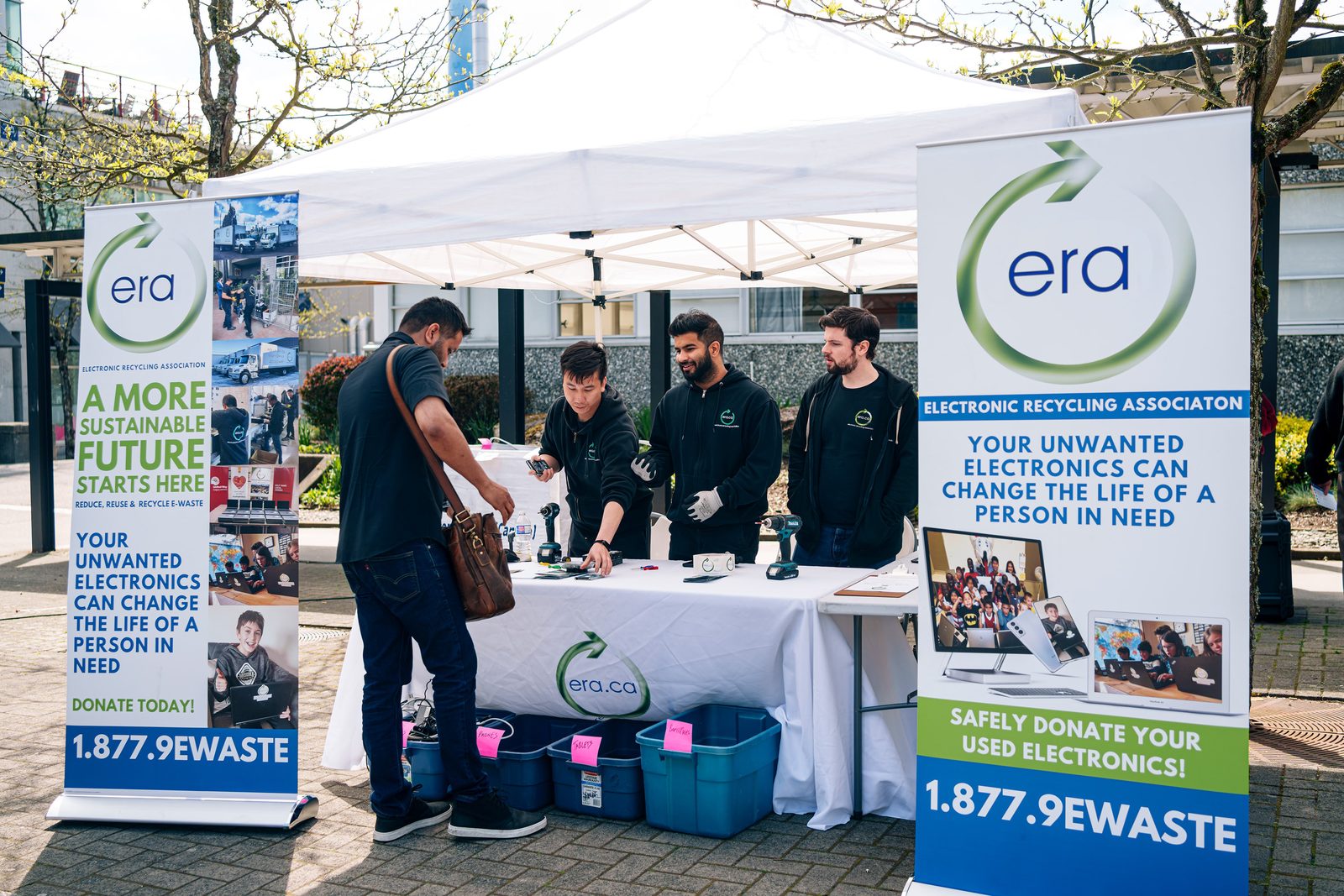 ERA team members receiving technology at a community collection event