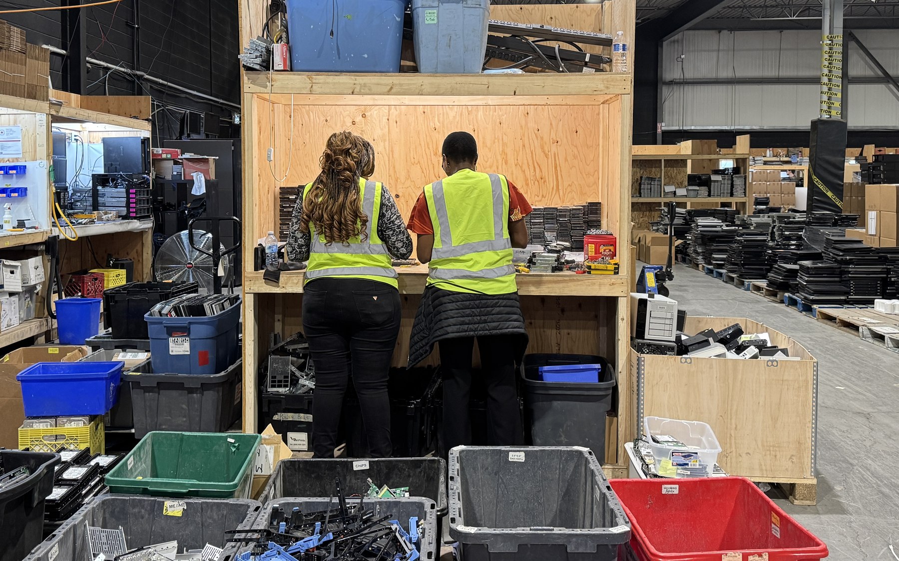 Volunteers sorting and preparing technology inside an ERA reuse facility
