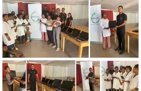 ERA programme partners presenting laptops to a community organisation