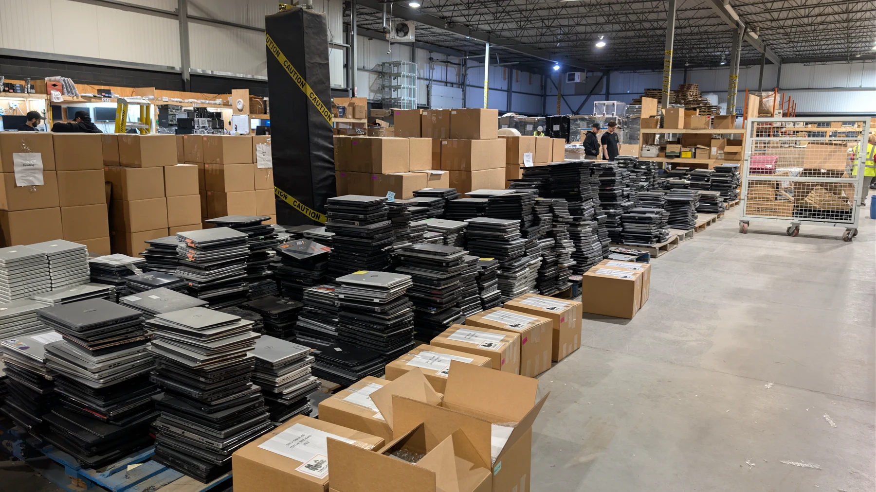 Rows of laptops and workplace technology sorted inside an ERA facility