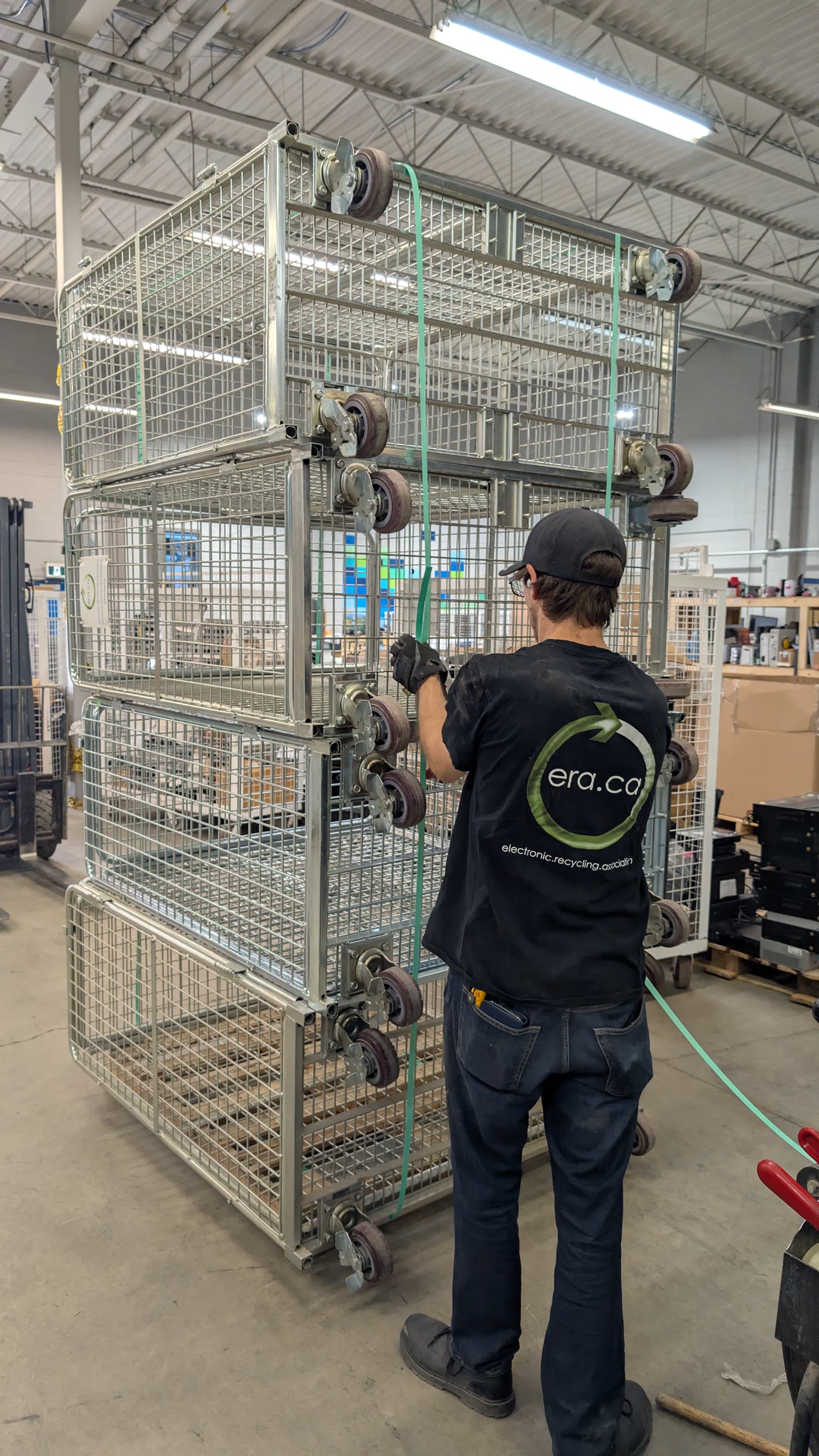 An ERA worker securing reusable transport cages inside a processing facility